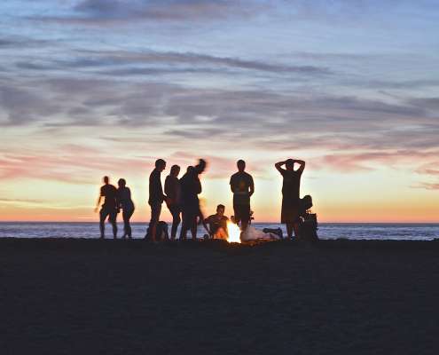 people enjoying company around a campfire