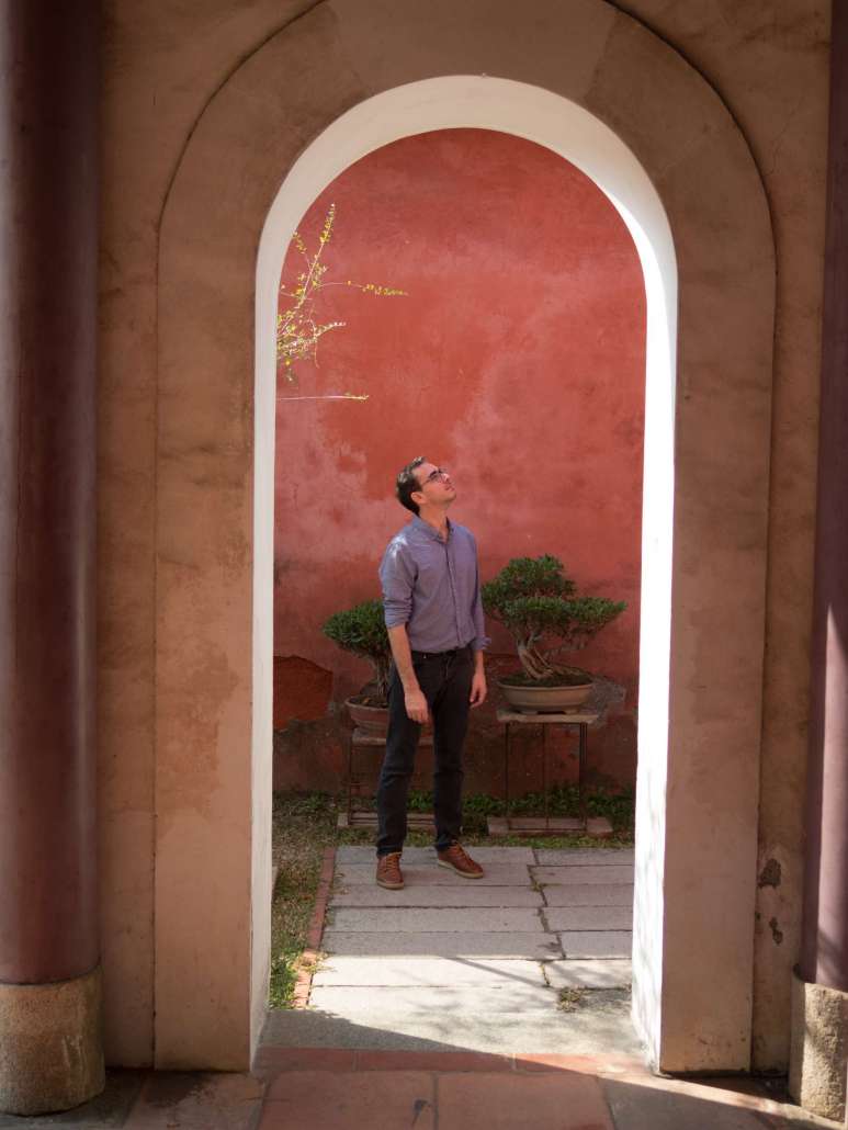 Nicolas Escoffier in standing the doorway of meditation taoist temple in tainan taiwan