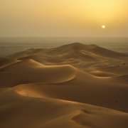 View of dunes in the desert at sunset