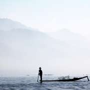 Fisherman on a small boat on a lake in Asia